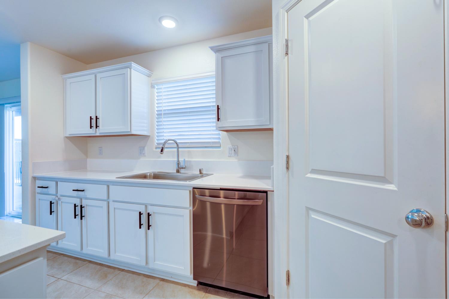 753 Heitz Way Merced, CA 95348 - Photo 29 of 70 a kitchen with white cabinets and sink