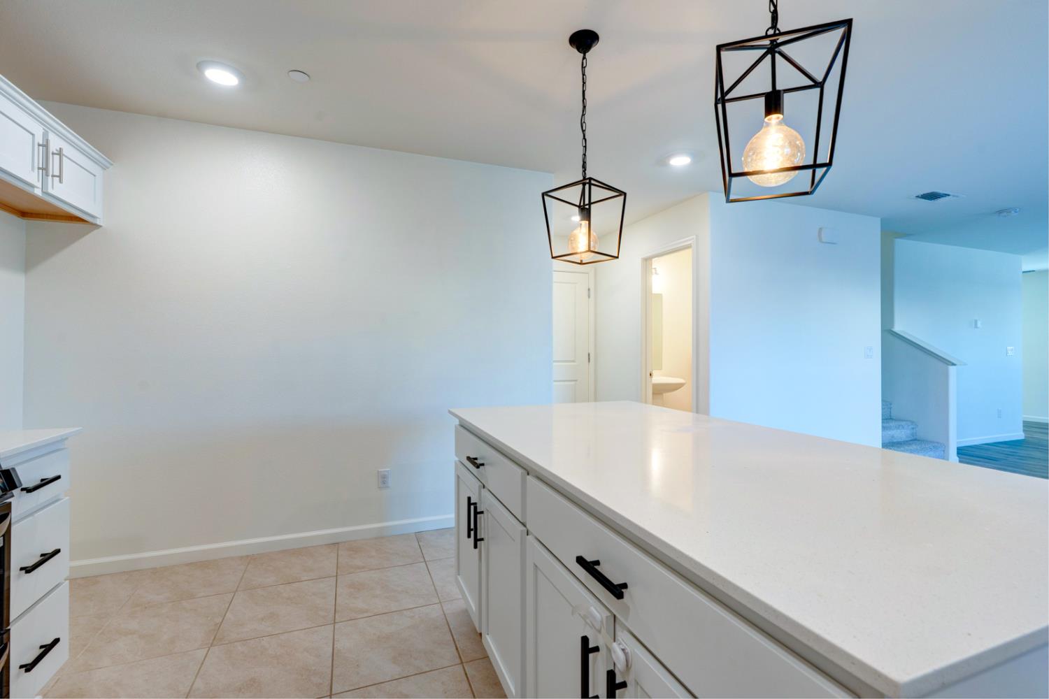 753 Heitz Way Merced, CA 95348 - Photo 30 of 70 a room with a chandelier and wooden floor