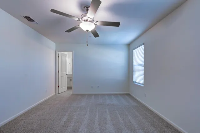 a view of a hallway with closet and a bathroom