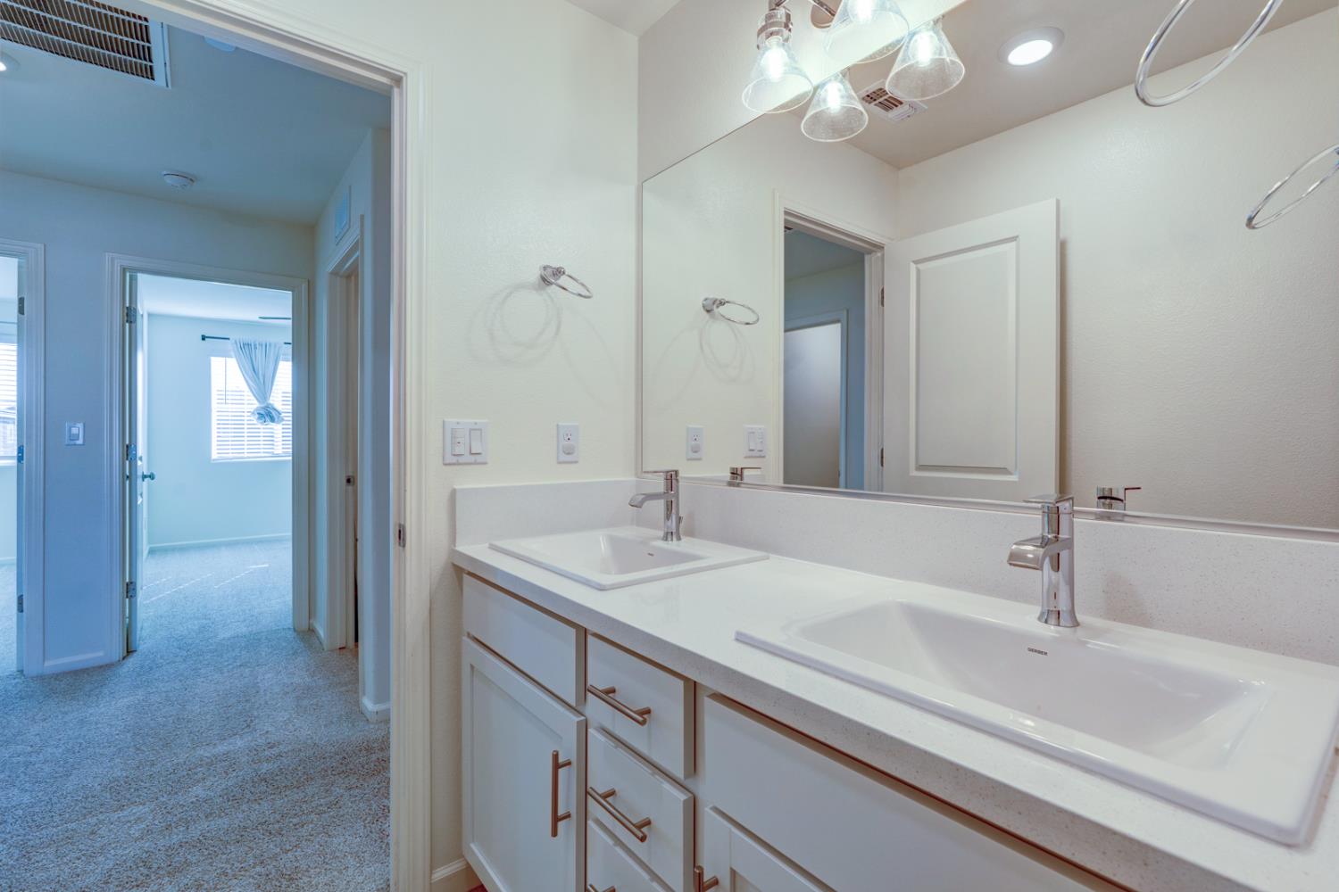 753 Heitz Way Merced, CA 95348 - Photo 46 of 70 a bathroom with a sink double vanity and a mirror