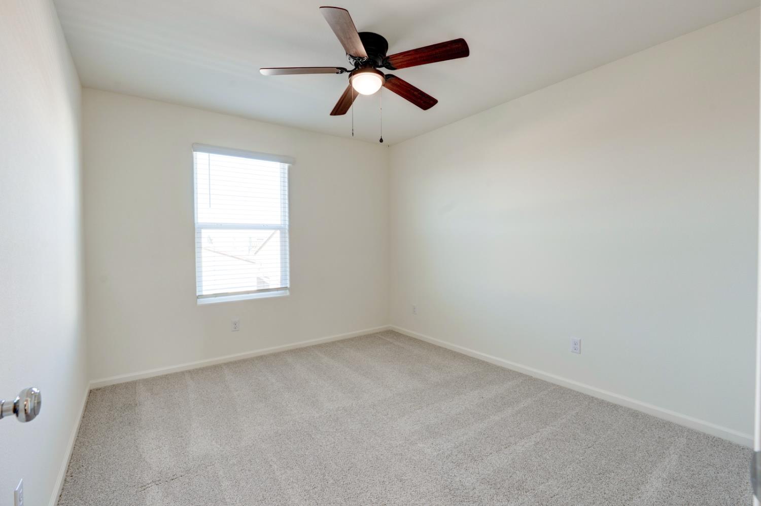 753 Heitz Way Merced, CA 95348 - Photo 48 of 70 an empty room with a window and a fan
