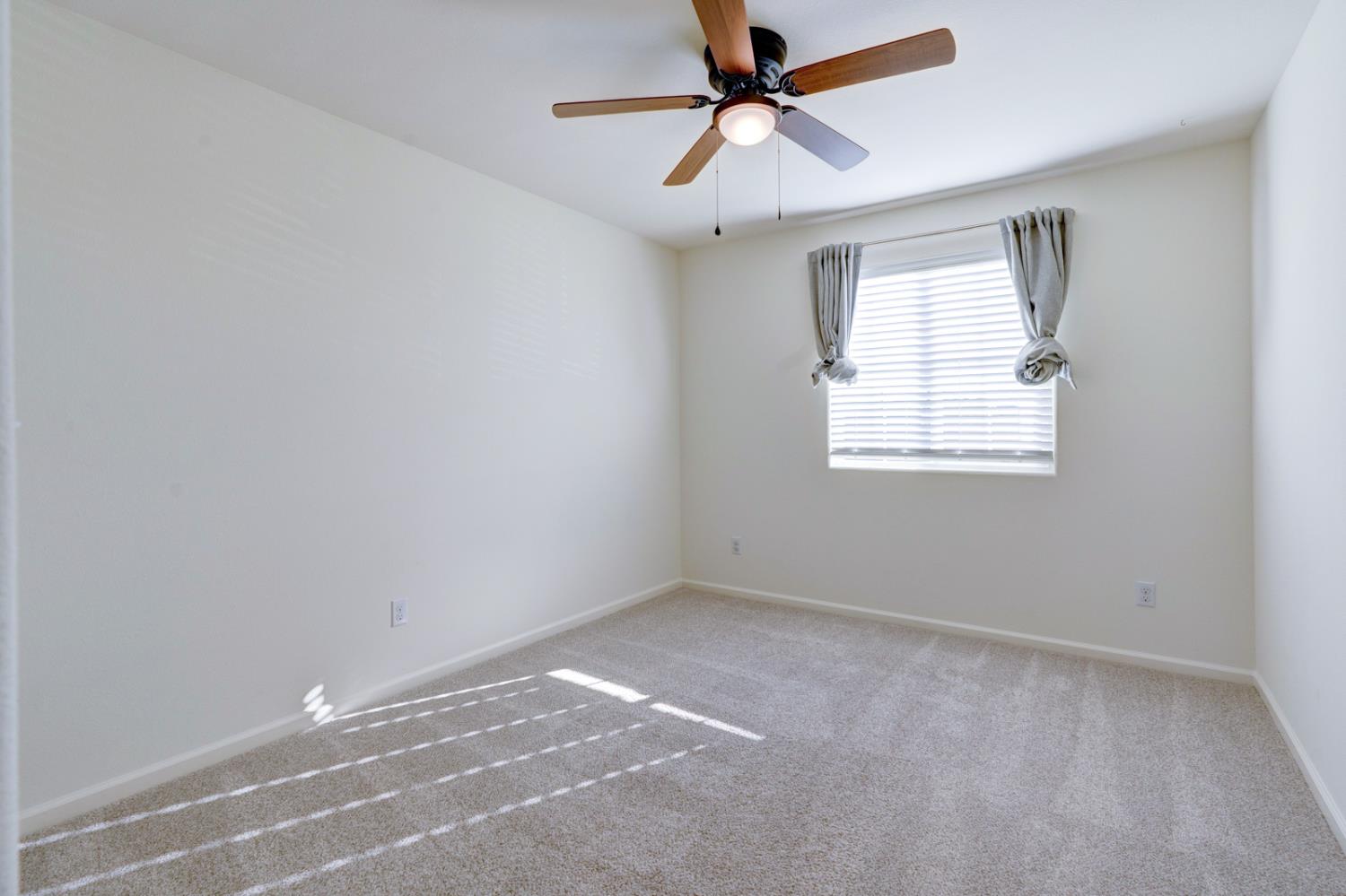 753 Heitz Way Merced, CA 95348 - Photo 50 of 70 an empty room with windows and fan