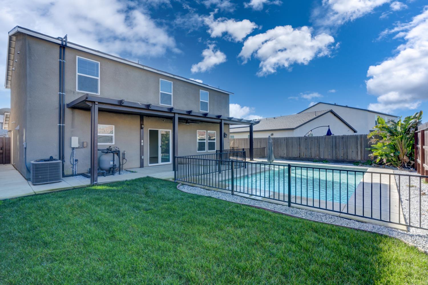 753 Heitz Way Merced, CA 95348 - Photo 65 of 70 a view of a house with a small yard and wooden fence