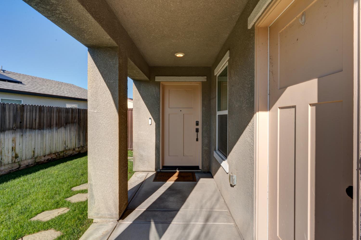 753 Heitz Way Merced, CA 95348 - Photo 7 of 70 a view of entryway with yard and outdoor seating
