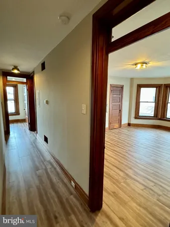 a view of a hallway with wooden floor