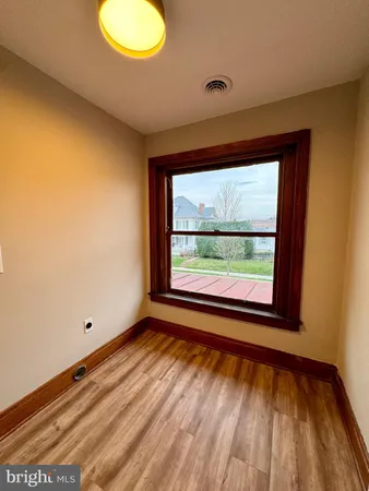 a view of room with window and hardwood floor
