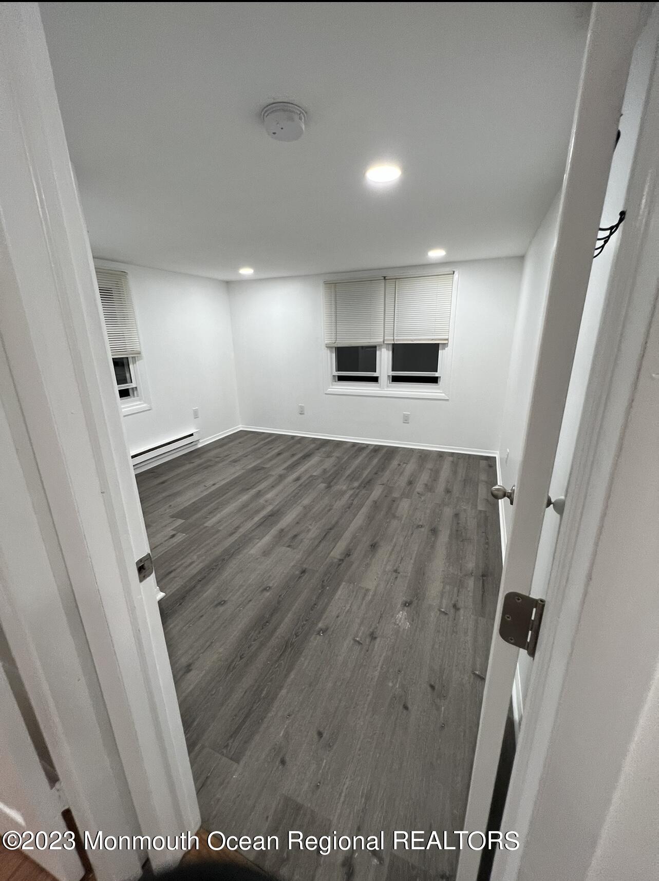 8a Washington Avenue, Unit B Matawan, NJ 07747 - Photo 14 of 16 an empty room with wooden floor and windows