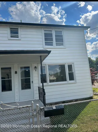 a view of a house with a small backyard