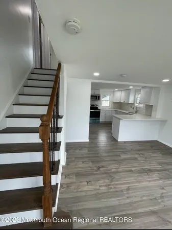 a view of kitchen with wooden floor and electronic appliances