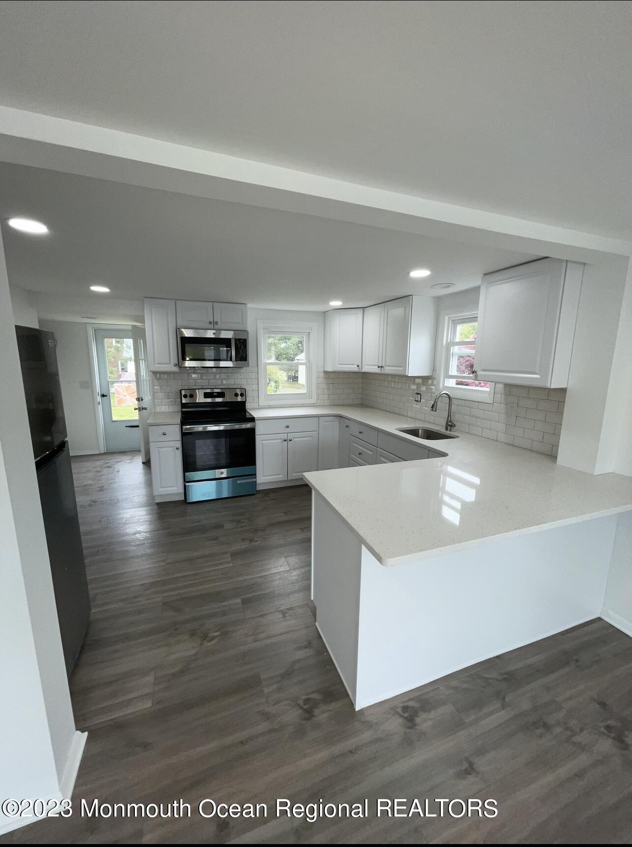 8a Washington Avenue, Unit B Matawan, NJ 07747 - Photo 4 of 16 a large kitchen with stainless steel appliances granite countertop a large counter top a stove a sink and a refrigerator