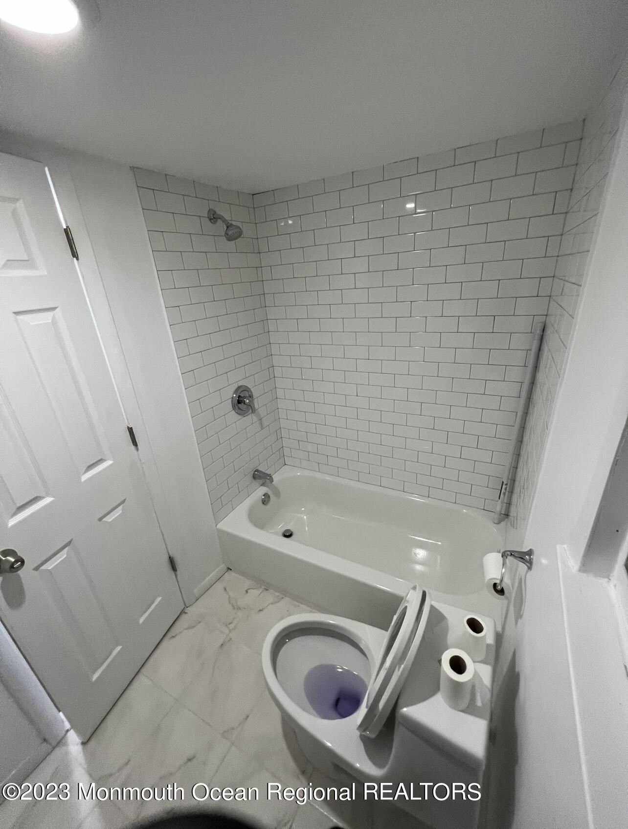 8a Washington Avenue, Unit B Matawan, NJ 07747 - Photo 10 of 16 a bathroom with a toilet a sink a mirror and shower