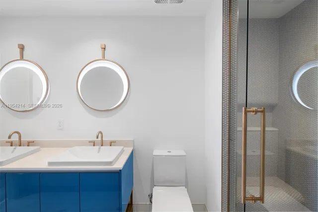 a bathroom with a double vanity sink and a mirror
