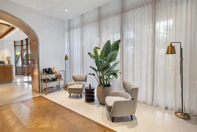 a living room with furniture flowerpot and a potted plant
