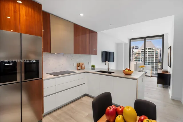 a kitchen with a sink appliances and cabinets