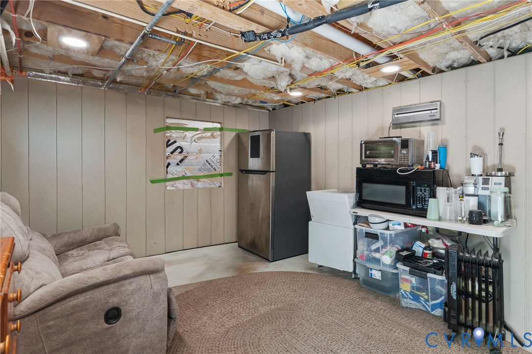 1755 Dispatch Road Quinton, VA 23141 - Photo 64 of 86 a living room with lots of furniture and a refrigerator