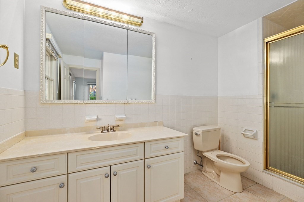 10 Pine Grove Road Hingham, MA 02043 - Photo 18 of 27 a bathroom with a toilet sink and a mirror