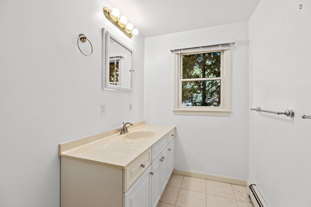 10 Pine Grove Road Hingham, MA 02043 - Photo 20 of 27 a bathroom with a sink a mirror and a window