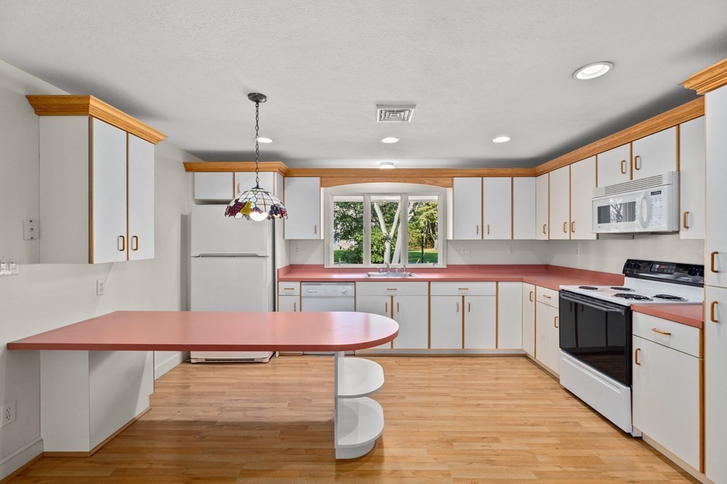10 Pine Grove Road Hingham, MA 02043 - Photo 3 of 27 a kitchen with stainless steel appliances granite countertop a stove a sink dishwasher and a refrigerator with wooden floor