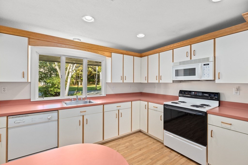 10 Pine Grove Road Hingham, MA 02043 - Photo 4 of 27 a kitchen with granite countertop white cabinets and white appliances