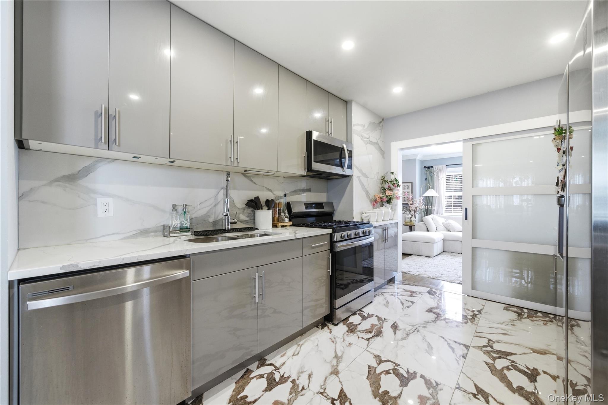 192 Mill Road Valley Stream, NY 11581 - Photo 11 of 26 a kitchen with granite countertop a refrigerator and a stove top oven