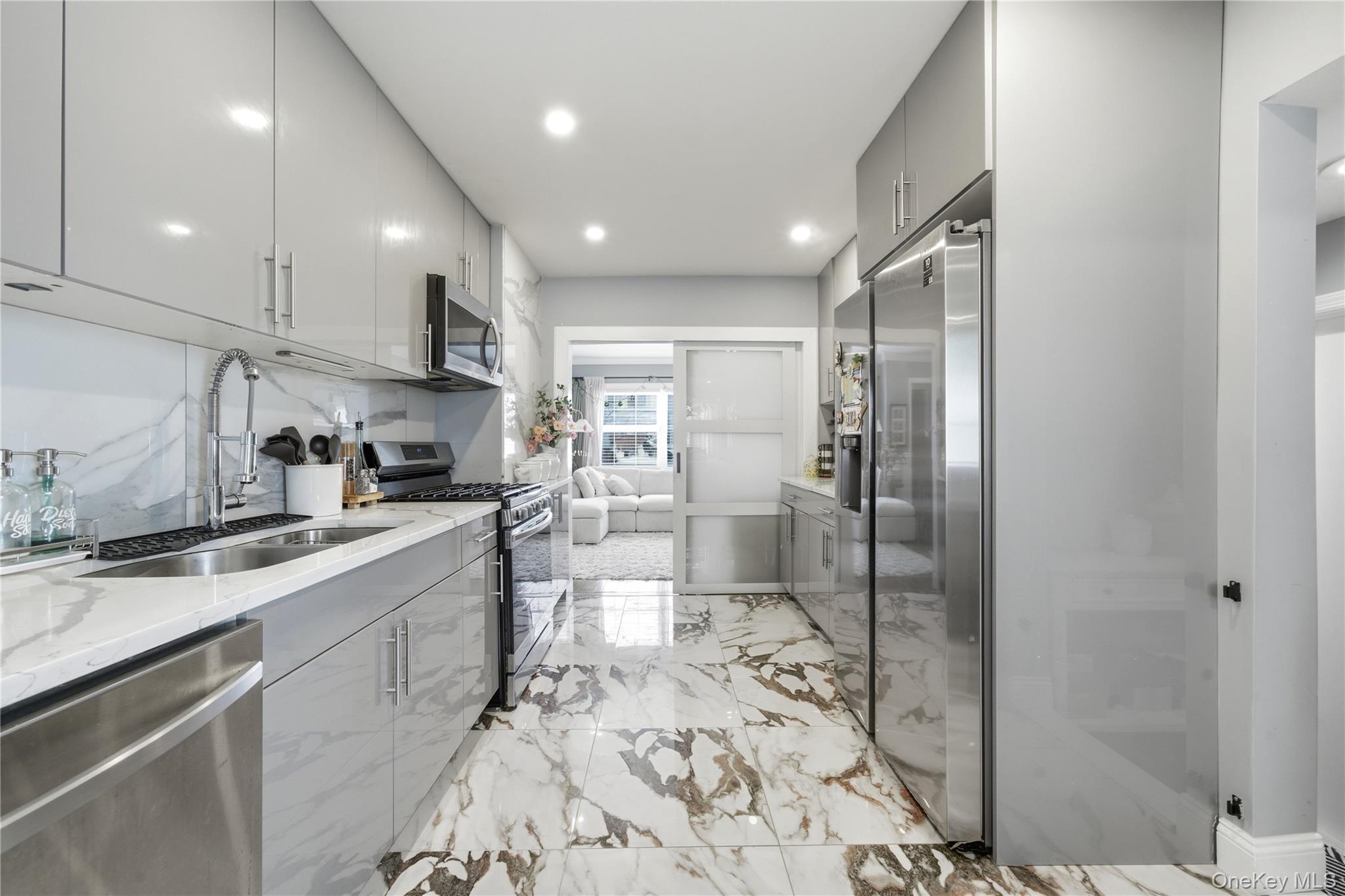 192 Mill Road Valley Stream, NY 11581 - Photo 12 of 26 a kitchen with stainless steel appliances granite countertop a sink refrigerator and cabinets