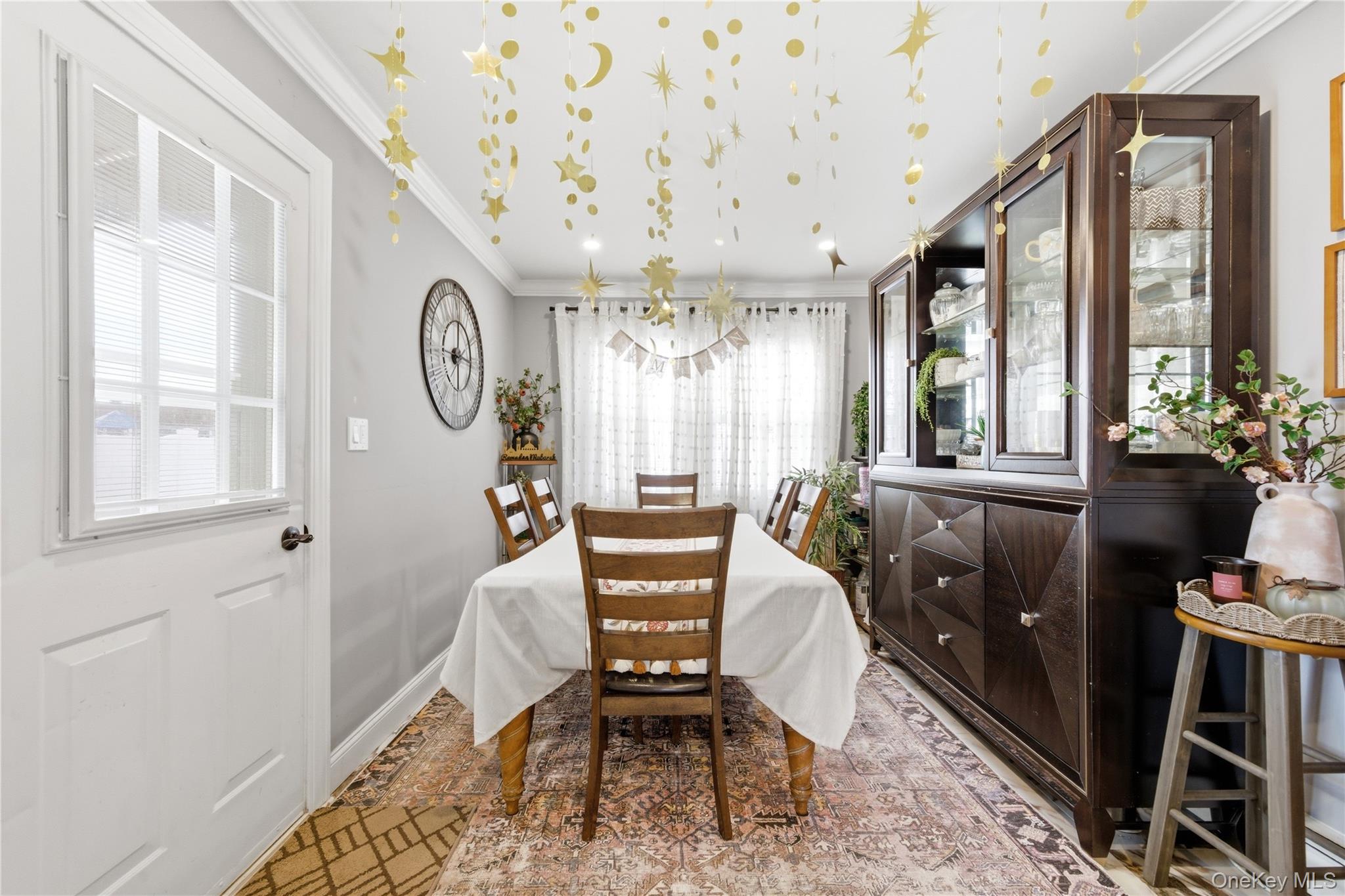 192 Mill Road Valley Stream, NY 11581 - Photo 17 of 26 a living room with furniture a window and a chandelier