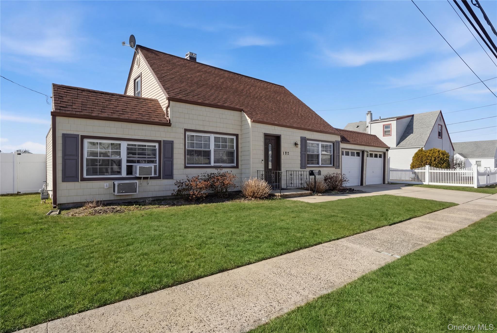 192 Mill Road Valley Stream, NY 11581 - Photo 2 of 26 a front view of a house with a yard