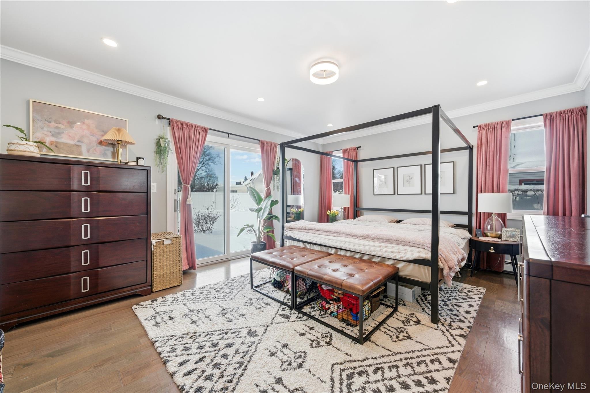 192 Mill Road Valley Stream, NY 11581 - Photo 4 of 26 a bedroom with a bed a dresser and next to a window