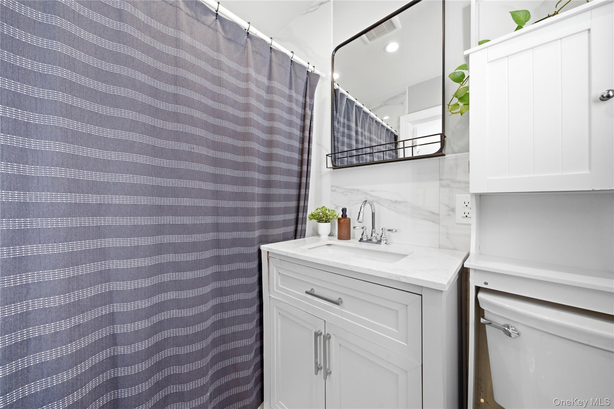 192 Mill Road Valley Stream, NY 11581 - Photo 6 of 26 a bathroom with a sink and a mirror