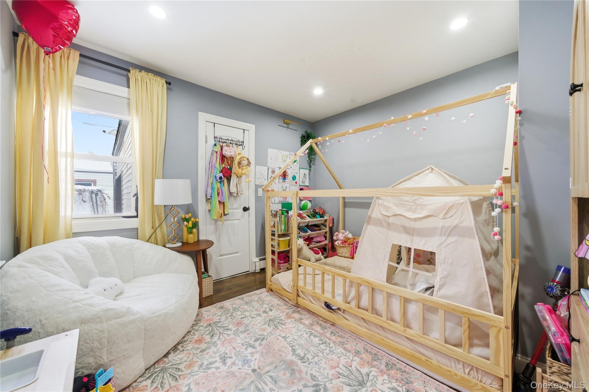 192 Mill Road Valley Stream, NY 11581 - Photo 7 of 26 a living room with furniture and a flat screen tv