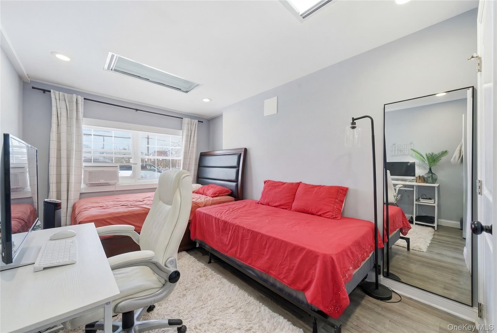 192 Mill Road Valley Stream, NY 11581 - Photo 9 of 26 a bedroom with a bed and large window