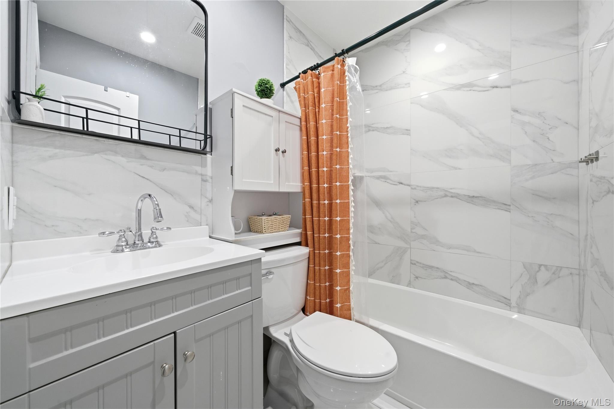192 Mill Road Valley Stream, NY 11581 - Photo 10 of 26 a bathroom with a sink a toilet and shower