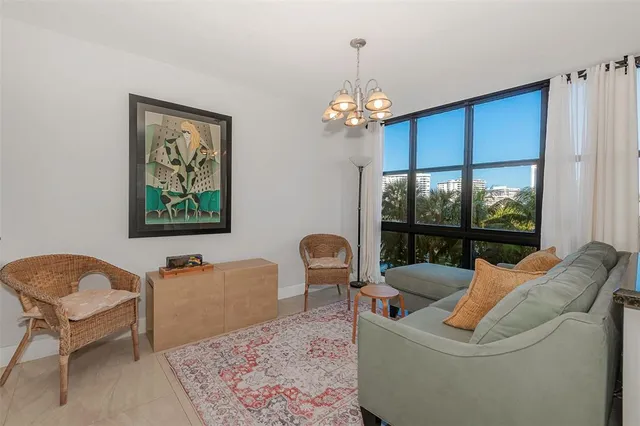 a living room with furniture a window and a chandelier