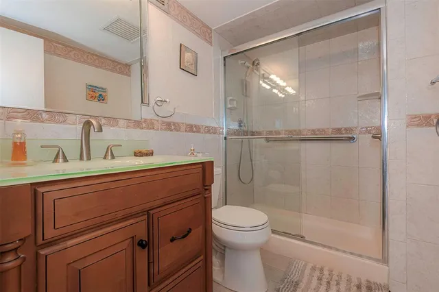 a bathroom with a sink a mirror and a shower