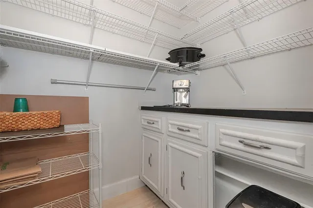 a bedroom with a bed and a large mirror