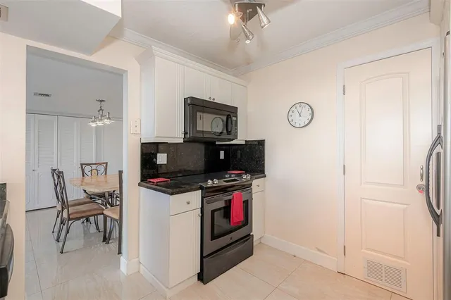 a kitchen with stainless steel appliances granite countertop a stove and a refrigerator