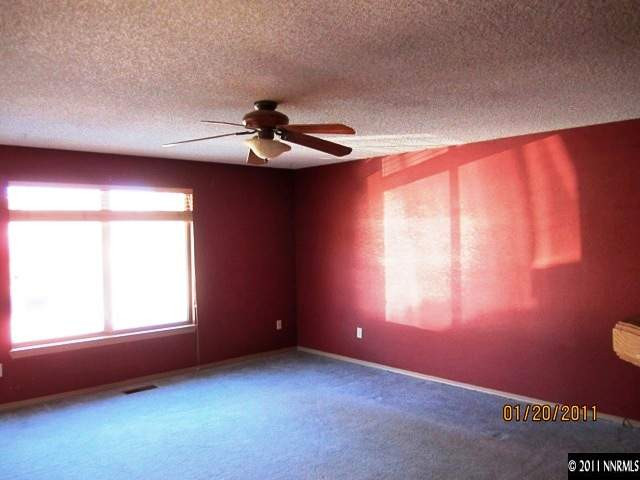 164 Roughing It Road Dayton, NV 89403 - Photo 4 of 11 an empty room with windows and fan