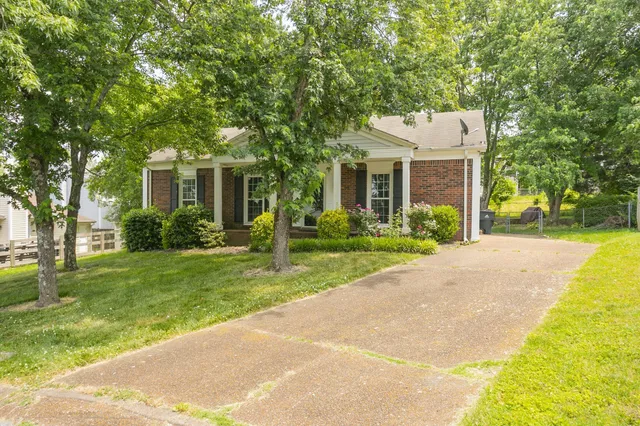 a front view of house with yard and green space