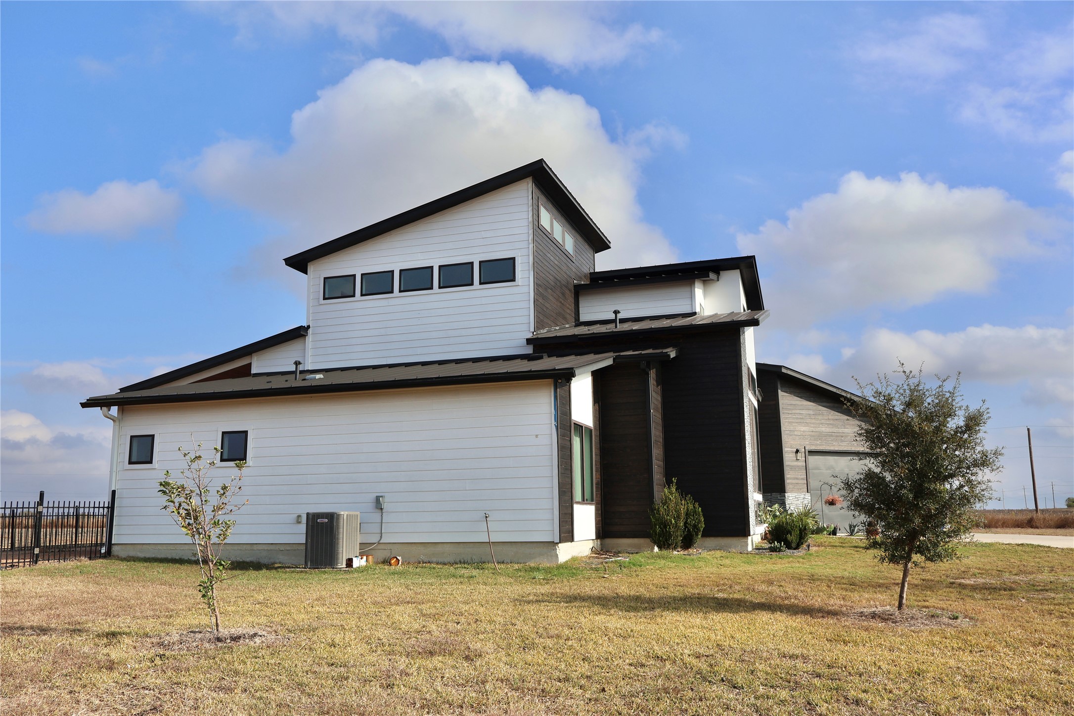 17216 Lund - Carlson Road Elgin, TX 78621 - Photo 13 of 17 Rear view of house featuring a garage