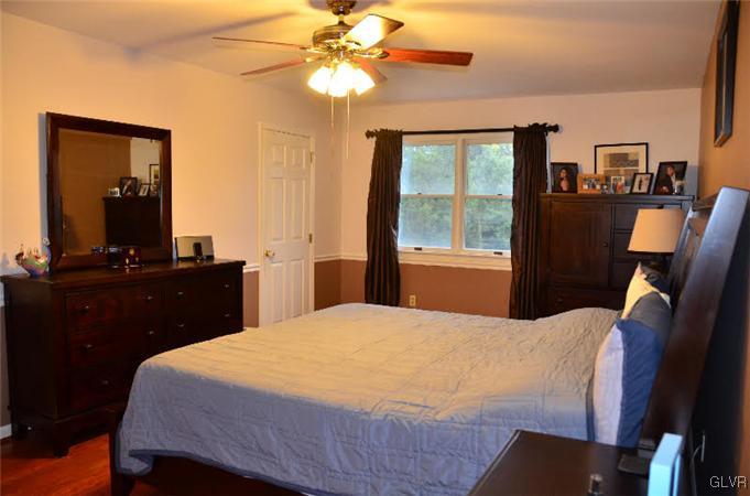 3305 Fischer Road Easton, PA 18045 - Photo 11 of 16 a bedroom with a bed and a chandelier