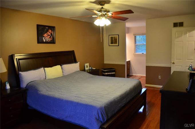 3305 Fischer Road Easton, PA 18045 - Photo 9 of 16 a bedroom with a bed and a chandelier