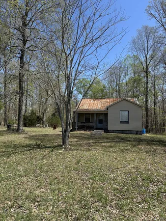 a house that has a tree in front of it