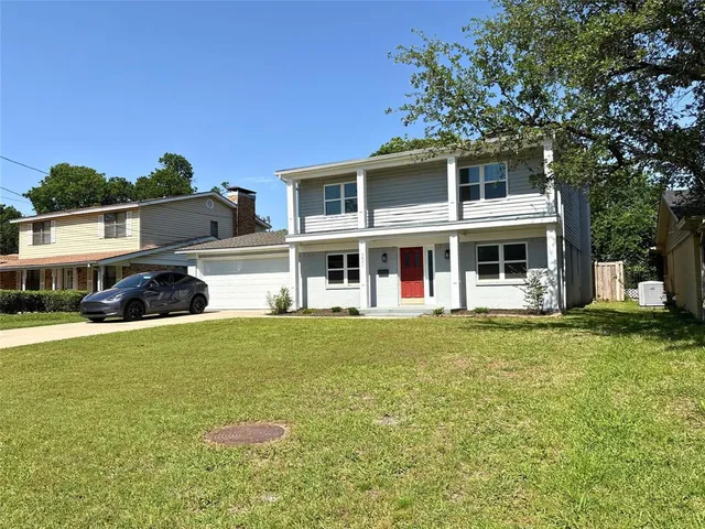 a front view of a house with a garden