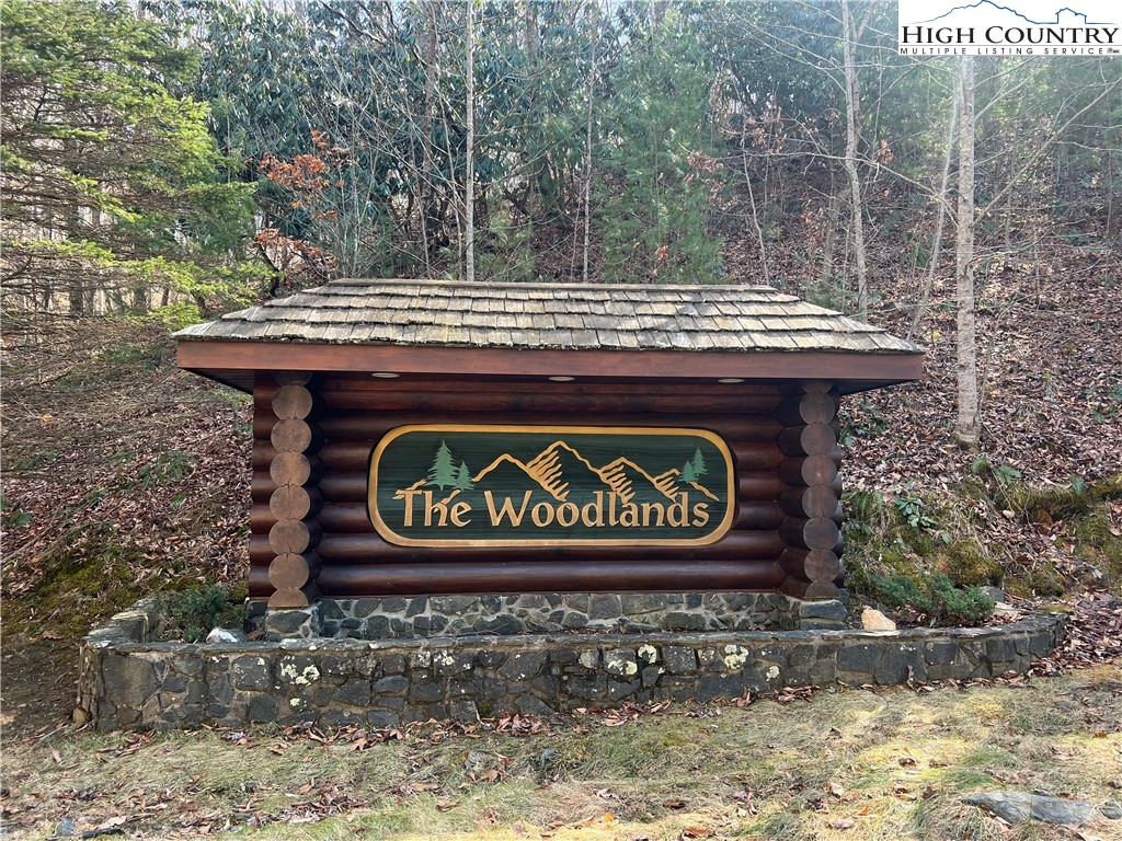 Woodland Ridge Lansing, NC 28643 - Photo 2 of 10 a sign that is sitting on a brick wall