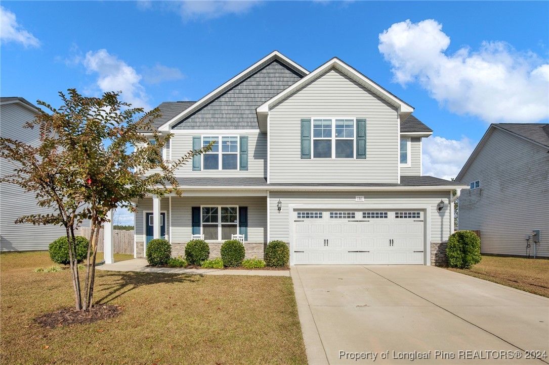 181 Chatfield Dr. Raeford, NC 28376 - Photo 1 of 36 a front view of a house with a yard and garage
