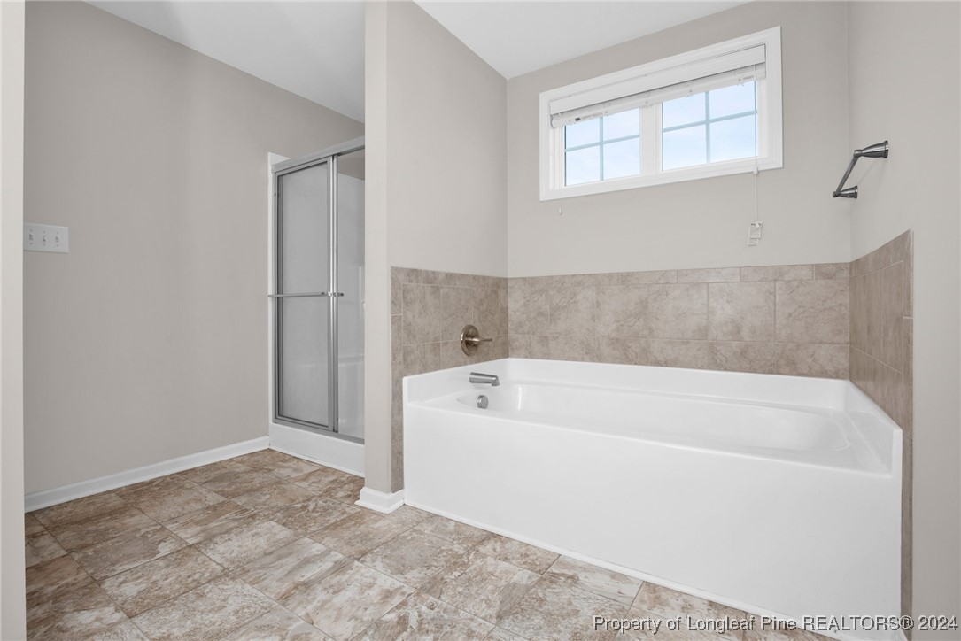 181 Chatfield Dr. Raeford, NC 28376 - Photo 20 of 36 a white bath tub sitting in a bathroom