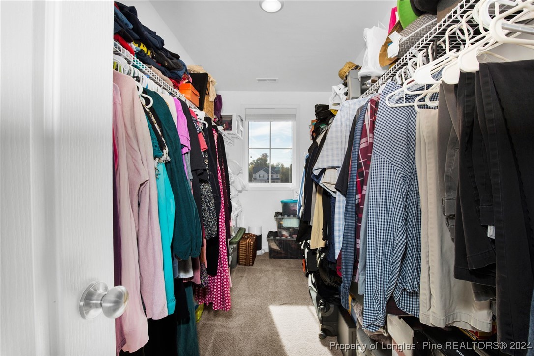 181 Chatfield Dr. Raeford, NC 28376 - Photo 21 of 36 a view of walk in closet with clothes and shoes
