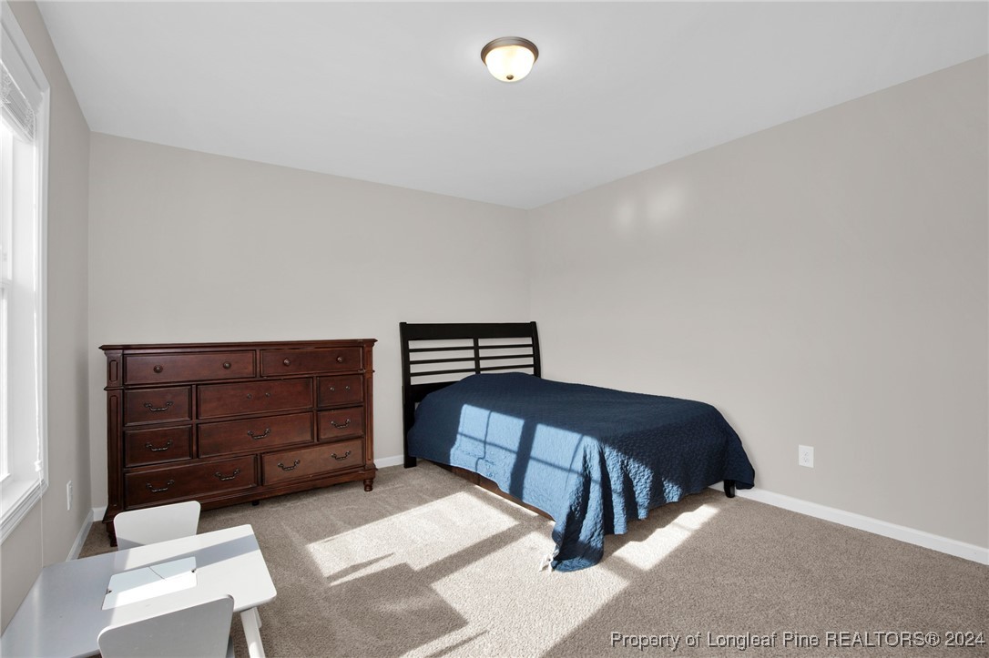 181 Chatfield Dr. Raeford, NC 28376 - Photo 25 of 36 a bedroom with a bed and window