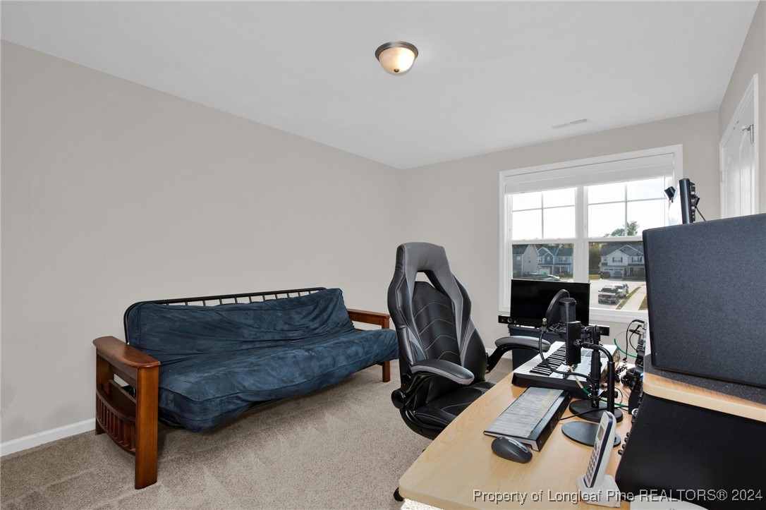 181 Chatfield Dr. Raeford, NC 28376 - Photo 26 of 36 a living room with furniture a flat screen tv and a window