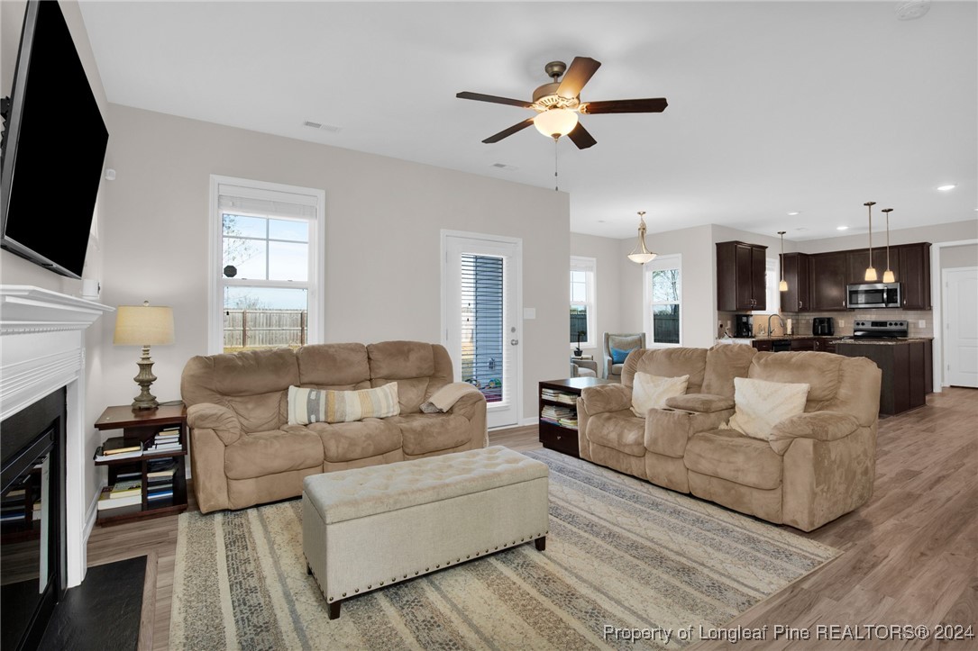 181 Chatfield Dr. Raeford, NC 28376 - Photo 5 of 36 a living room with fireplace furniture and a flat screen tv